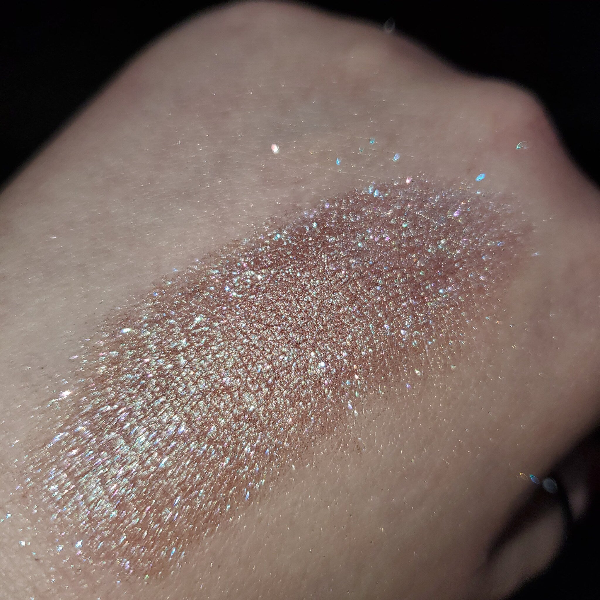 Vibrant fan art-inspired eye shadow palette with bold colors in sleek black compact packaging