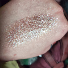 Close-up of vibrant fan art-inspired eye shadow palette with bold metallic and matte color swatches