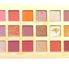 Close-up of 18 vibrant blue eyeshadow shades in matte, shimmer, and metallic finishes with smooth pigmented texture