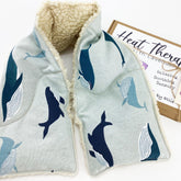 Wheat bag shoulder wrap with whale print, light blue fabric, and fluffy white trim