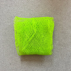 Green mesh material on a textured gray background