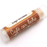 Lip balm tube with brown and white label, "Café con leche" text, clear cap