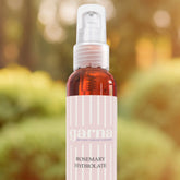 Toner spray bottle with clear, brown liquid, pink label, and Garna brand text