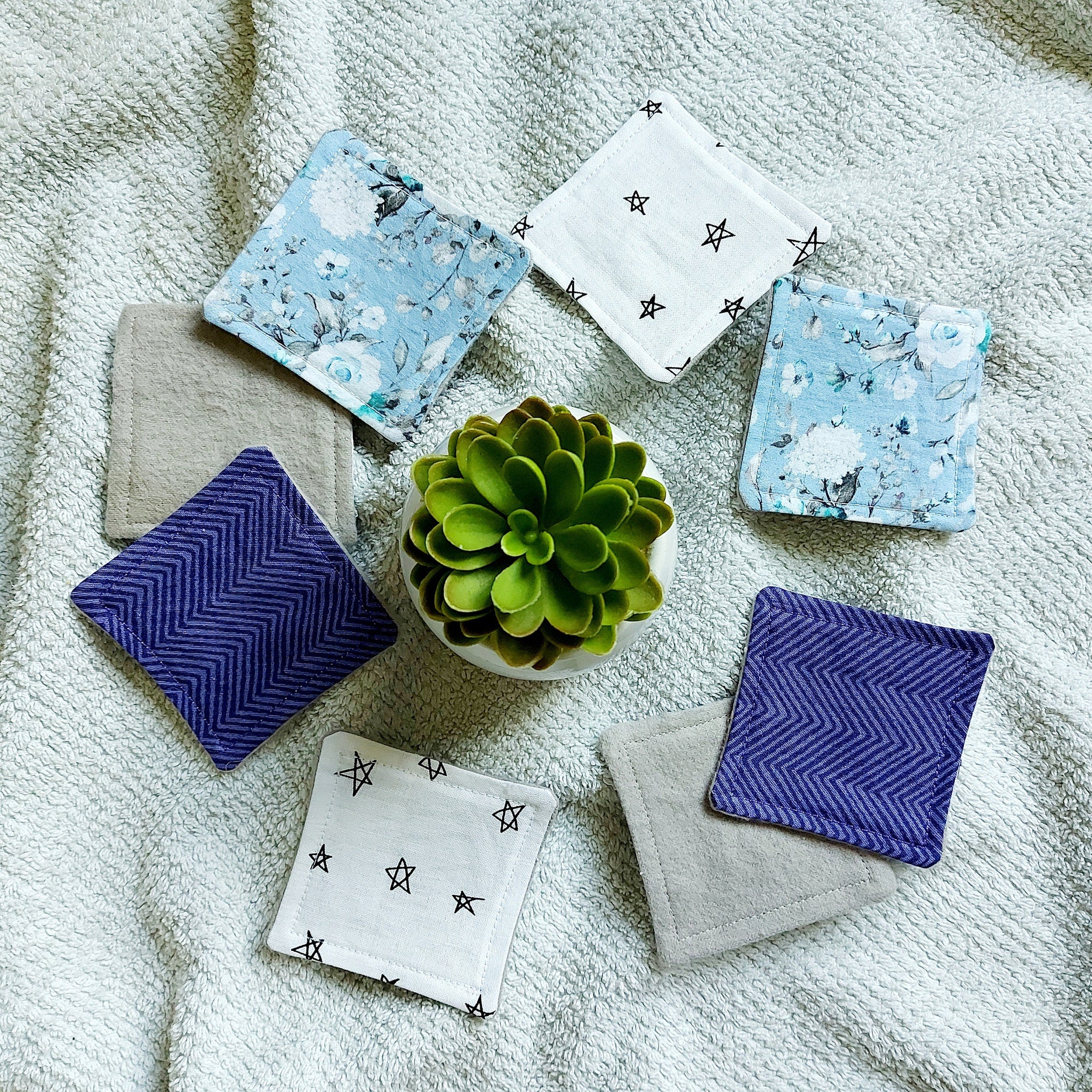 Makeup remover pads with floral, star, and zig-zag patterns, in blue, white, and purple fabrics