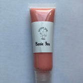 Lip gloss tube with peach color, clear plastic, and Glossy New You label