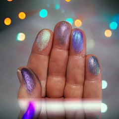 Hand applying shimmery duochrome eyeshadow from 5-color palette to eyelid with brush