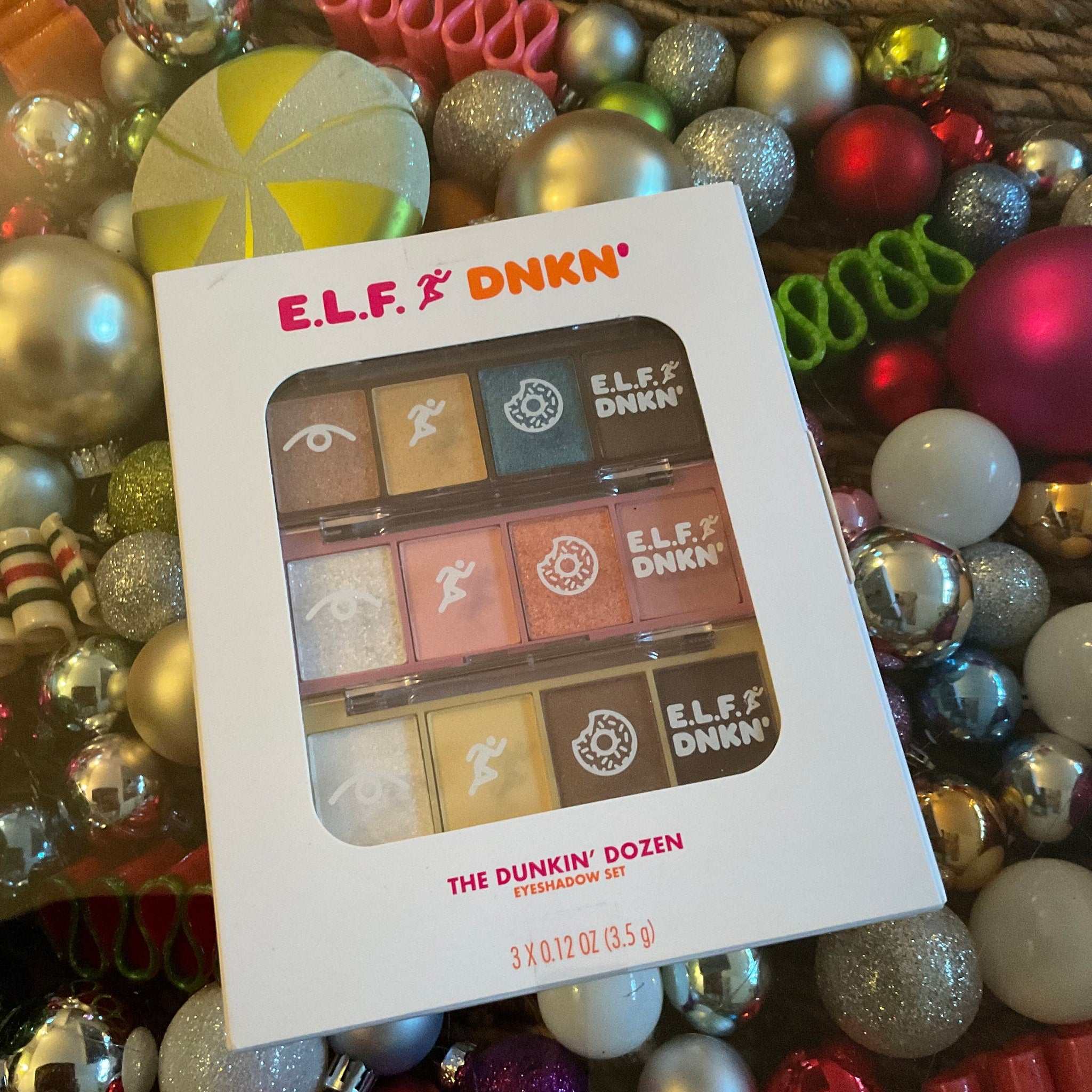 Eyeshadow palette with white packaging, multi-color shadows, and ELF DNKN branding