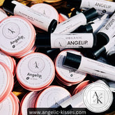 Lip balm tubes and tins in white, black, and pink with Angelip and Angelic Kisses branding