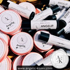 Lip balm tubes and tins in white, black, and pink with Angelip and Angelic Kisses branding