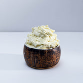 Minimalist white jar of vegan whipped shea body butter with eco-friendly reusable packaging and creamy texture