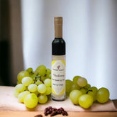 Chardonnay Lip Gloss, clear glass bottle, gold cap, with grapes and text