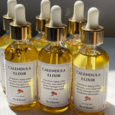 Calendula Elixir Facial Oil, amber liquid in glass bottles with gold caps, byLarose label visible