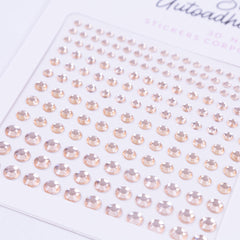 Close-up of gold vintage crystal face stickers with intricate designs, arranged on skin for luxurious adornment