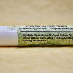 Lip balm tube with white and green label, text from GypsyBeeFarm, ingredients listed