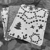 Makeup remover pads, gray and white fabric with festive print, stacked together