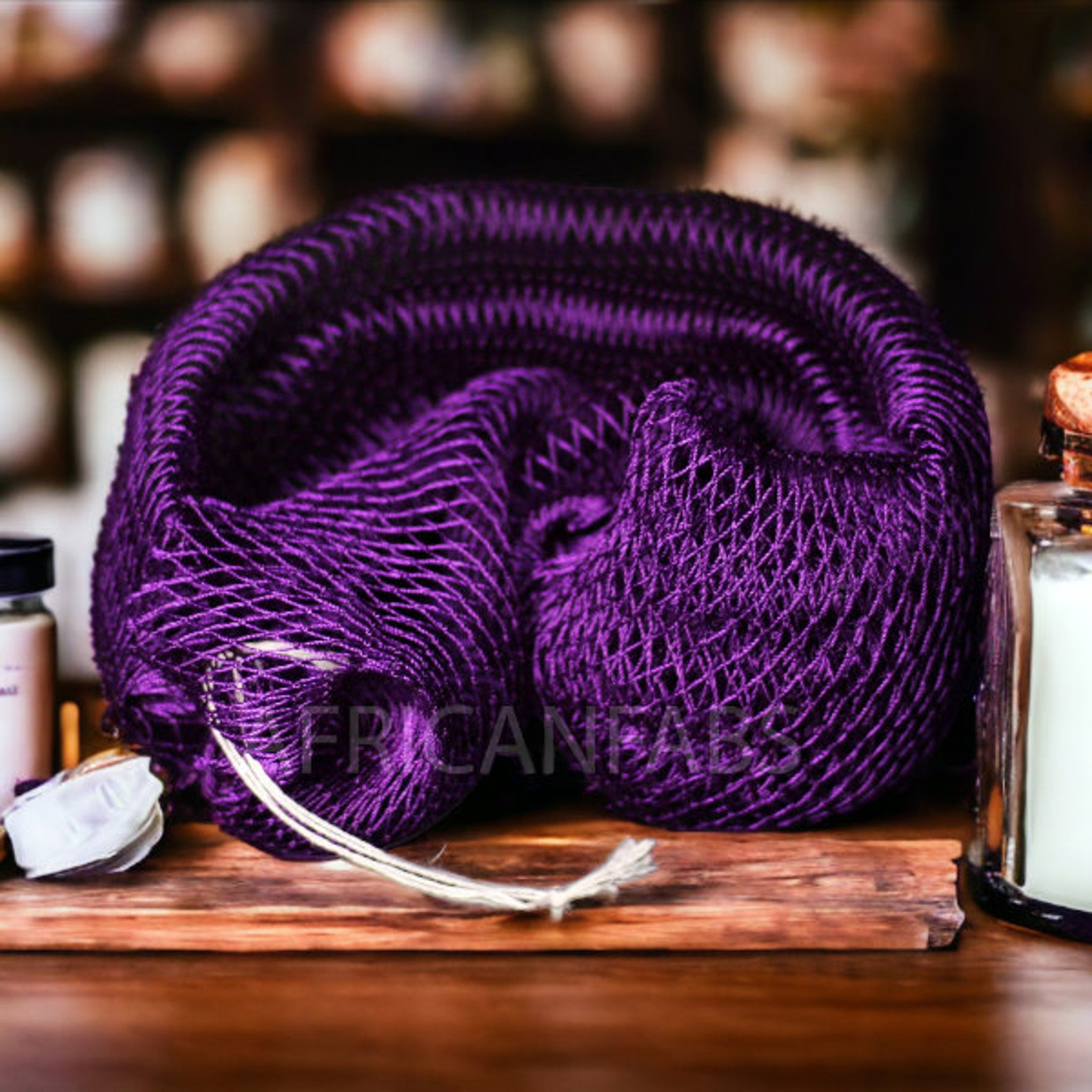 White textured exfoliating net sponge with looped handle for body scrubbing and acne treatment