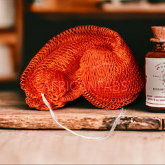 Close-up of textured African exfoliating net sponge with fine mesh for deep skin renewal and back acne treatment