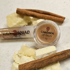 Lip balm with brown cinnamon, clear tube, and white butter chunks, Balm Squad brand