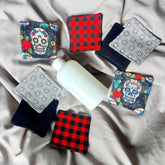 Makeup remover pads with plaid, skull, and geometric patterns, with a white bottle of liquid