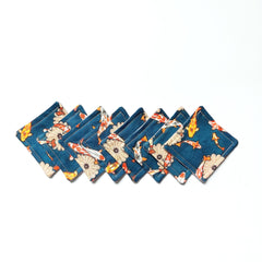 Coasters with teal koi fish pattern and stitched edges, arranged in a row