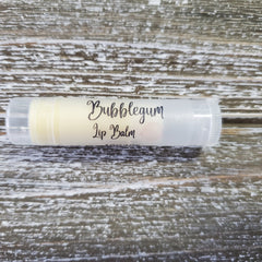 Lip balm tube with clear plastic, white label, and Bubblegum Lip Balm text on wooden background
