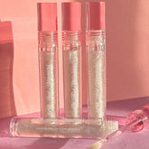 Lip gloss tubes with pink caps, clear tubes, and glittery contents, by PinkishPurrple