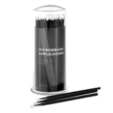 Microbrush applicators, black plastic sticks with white tips, in a clear container, Nanolash text visible