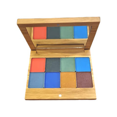 Hand applying shimmery bronze eyeshadow from vegan palette to eyelid with blending brush