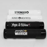 Lip balms, white and black tubes, with text "Yoga & Wine" and "peaceful WARRIOR