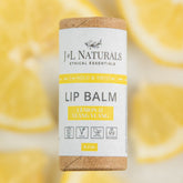 Lip balm tube with white label, brown cap, and J&L NATURALS text, lemon & ylang ylang flavor