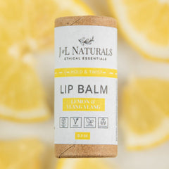 Lip balm tube with white label, brown cap, and J&L NATURALS text, lemon & ylang ylang flavor