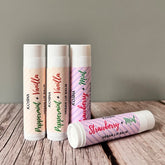 Vegan lip balm tubes in white with colored text and striped pattern, KOSHA brand visible
