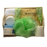 Aveeno gift basket with green, white, and wood-tone items for bath and body care