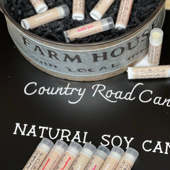 Lip balm tubes with tan labels, clear caps, and Country Road Candle Co branding displayed together