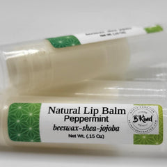 Lip balm tubes with white and green labels, BKind branding visible, product packaging