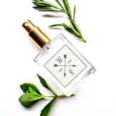 Facial toner bottle with gold cap, clear glass, and Wildflower label on white background