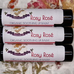Lip balm tubes with white labels, red text "Rosy Rosé", and black tubes, GypsyBeeFarm brand