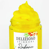 Facial cleanser balm in yellow, glass jar, with visible "Delizioso Skincare" label