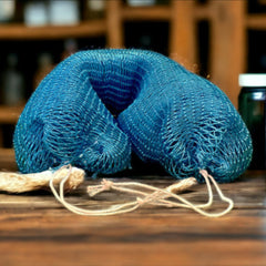 Close-up of textured African exfoliating net sponge with fine mesh weave against neutral background
