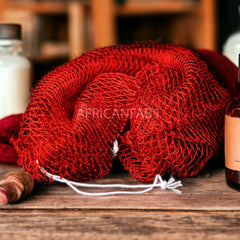 Close-up of textured African exfoliating net sponge with vibrant orange mesh for deep skin renewal and back acne care