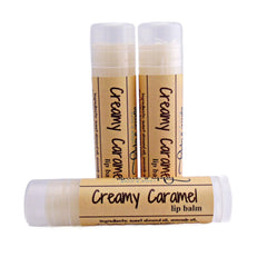 Lip balm tubes with beige paper labels and clear plastic caps, BluePoppyBath "Creamy Caramel" text