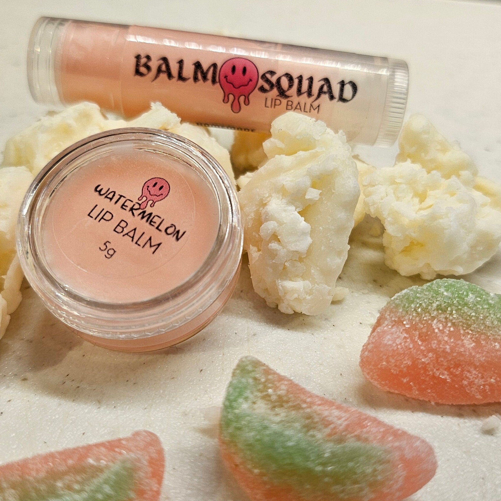 Lip balm with pink and clear packaging, watermelon flavor, and BalmSquadBeauty branding