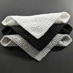 Close-up of black and white cotton face cloths showing soft texture and clean edges for gentle skincare routines