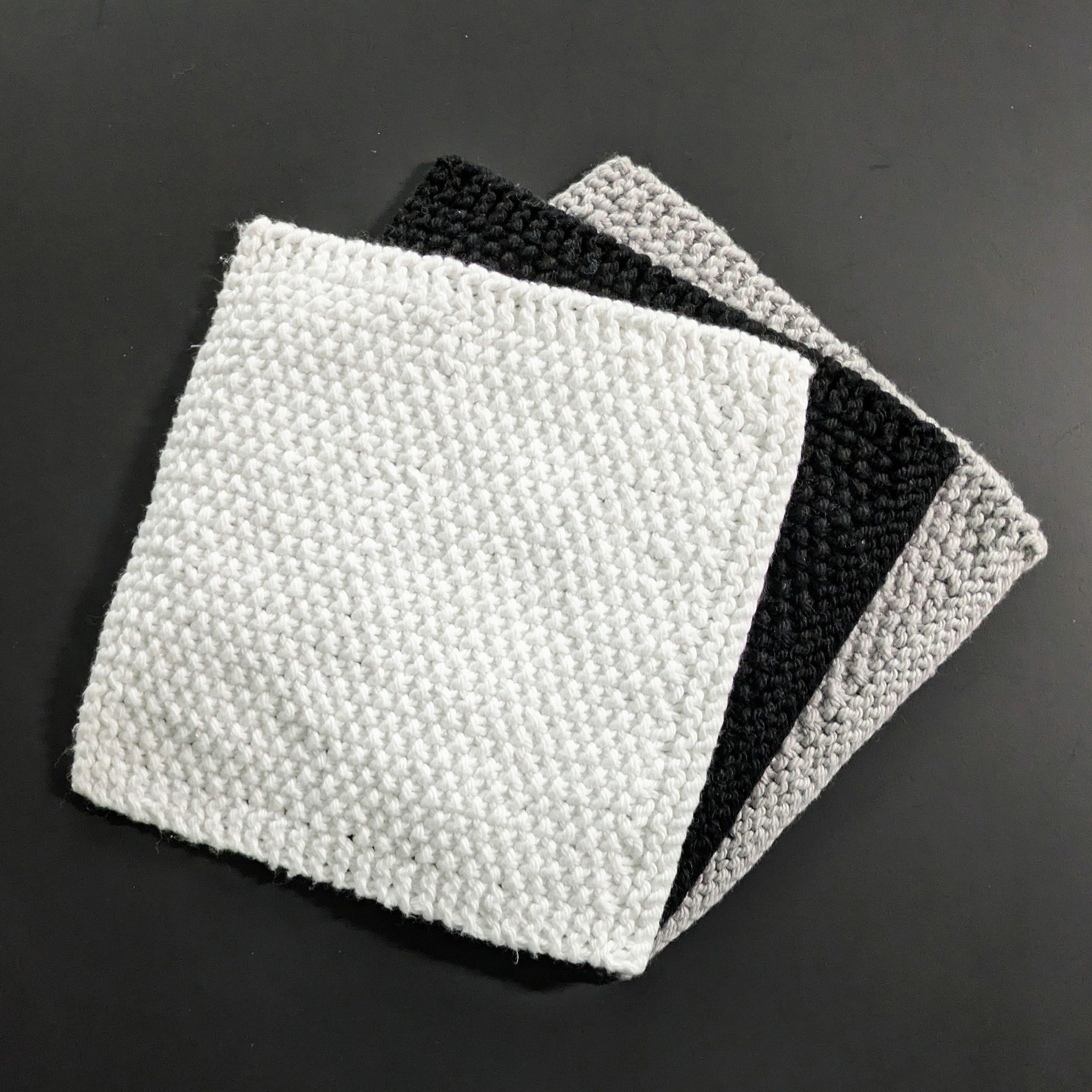 Set of two soft black and white cotton face cloths for gentle skincare routines