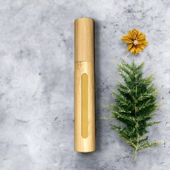 Bamboo tube with gold accent, natural wood grain, vertical style on gray surface