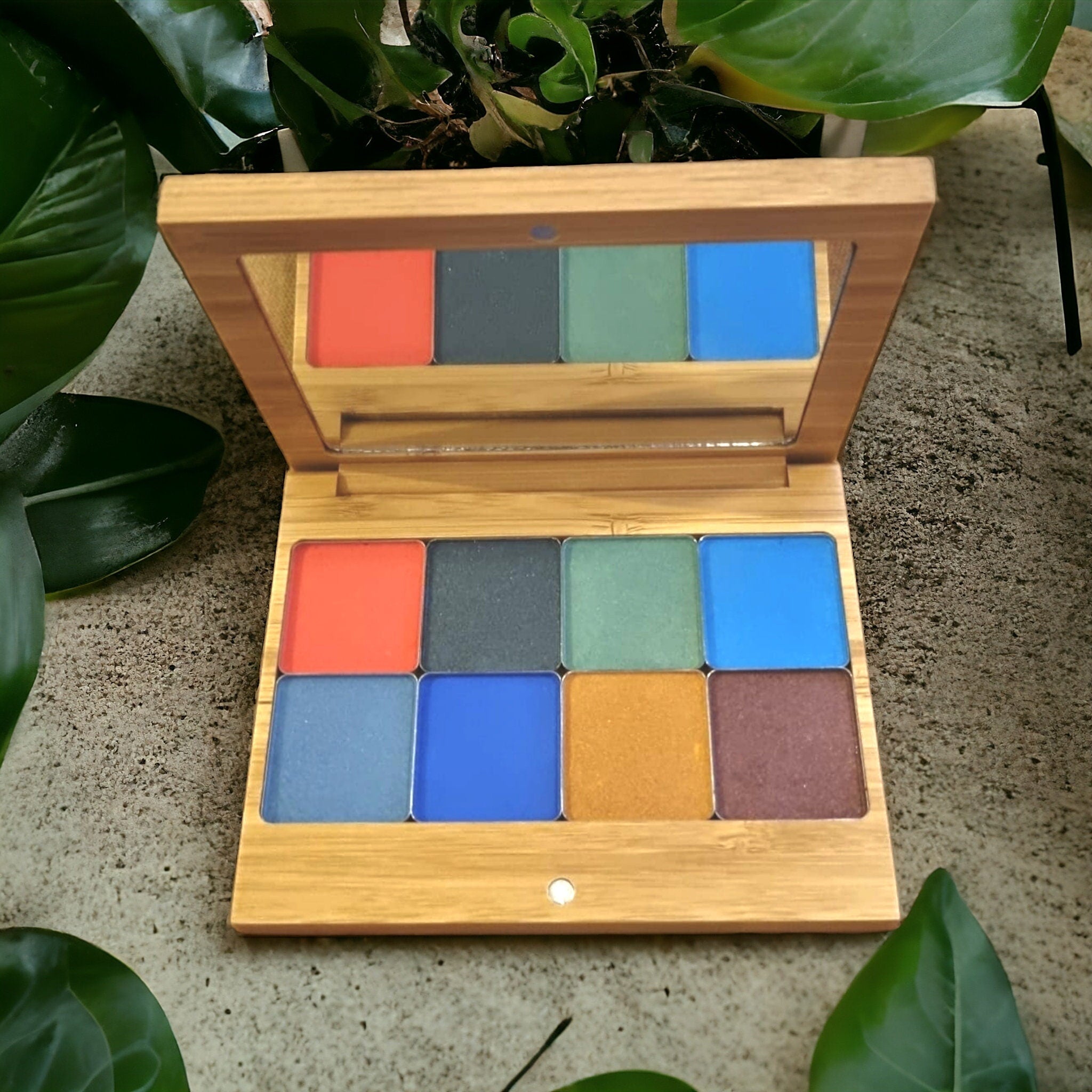 Vegan eyeshadow palette with warm autumn flower shades in matte and shimmer finishes, displayed open