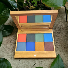 Vegan eyeshadow palette with warm autumn flower shades in matte and shimmer finishes, displayed open