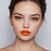 Lip gloss, orange matte lip color on model's lips, close-up shot of face