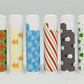 Christmas lip balms with various patterns, white tubes, and white caps