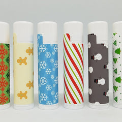 Christmas lip balms with various patterns, white tubes, and white caps
